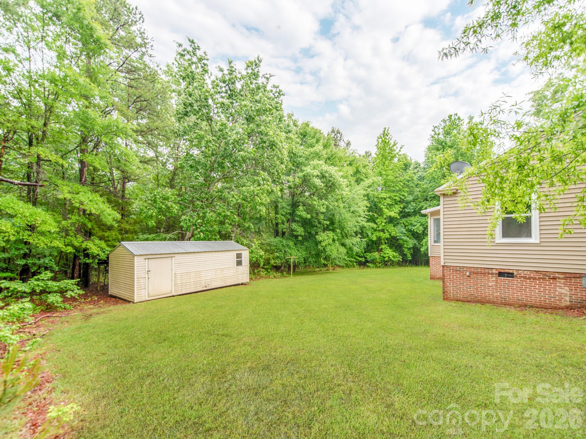 4699 Cherrystone Road Lancaster, SC 29720 - Photo 27 of 28 a view of a backyard with large trees