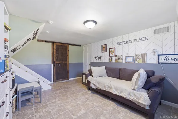 a living room with furniture and a ceiling fan