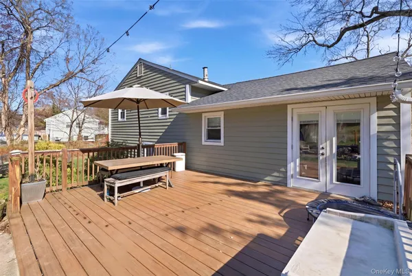 a backyard of a house with barbeque oven and outdoor seating