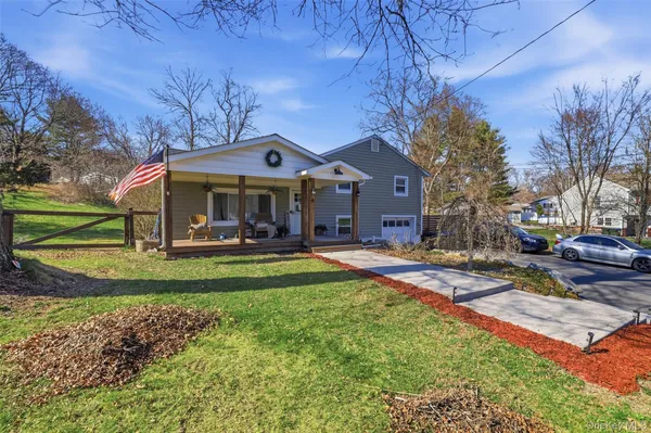 a view of a house with a yard patio and fire pit
