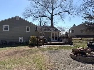 a view of a house with backyard and sitting area