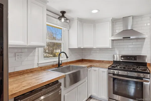 a kitchen with a sink stove top oven and cabinets