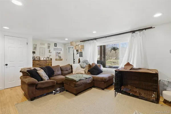 a living room with furniture ceiling fan and a window