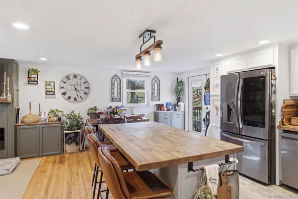 a view of a dining room with furniture and a chandelier