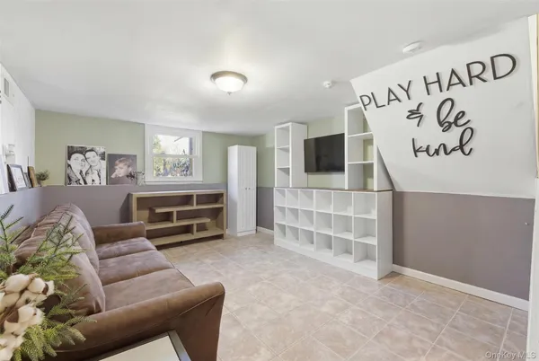a bedroom with furniture and a flat screen tv