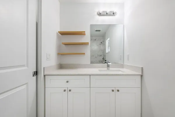 a bathroom with a sink and a mirror