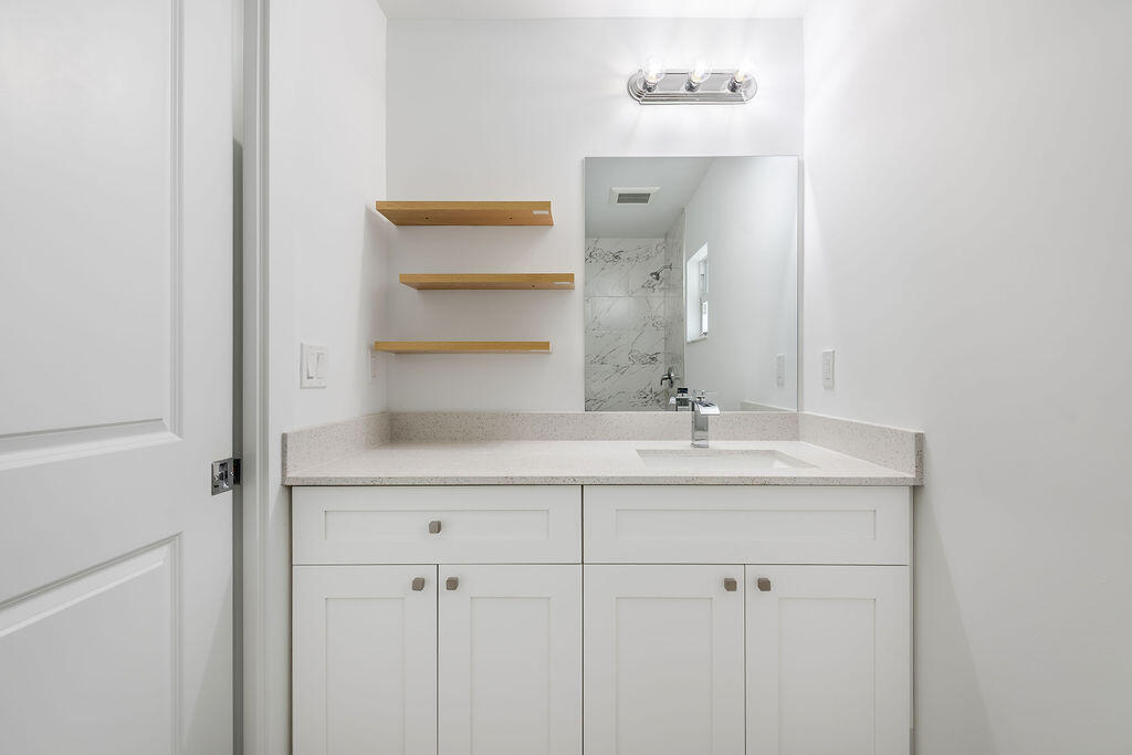 3246 Jefferson Street Stuart, FL 34997 - Photo 13 of 19 a bathroom with a sink and a mirror