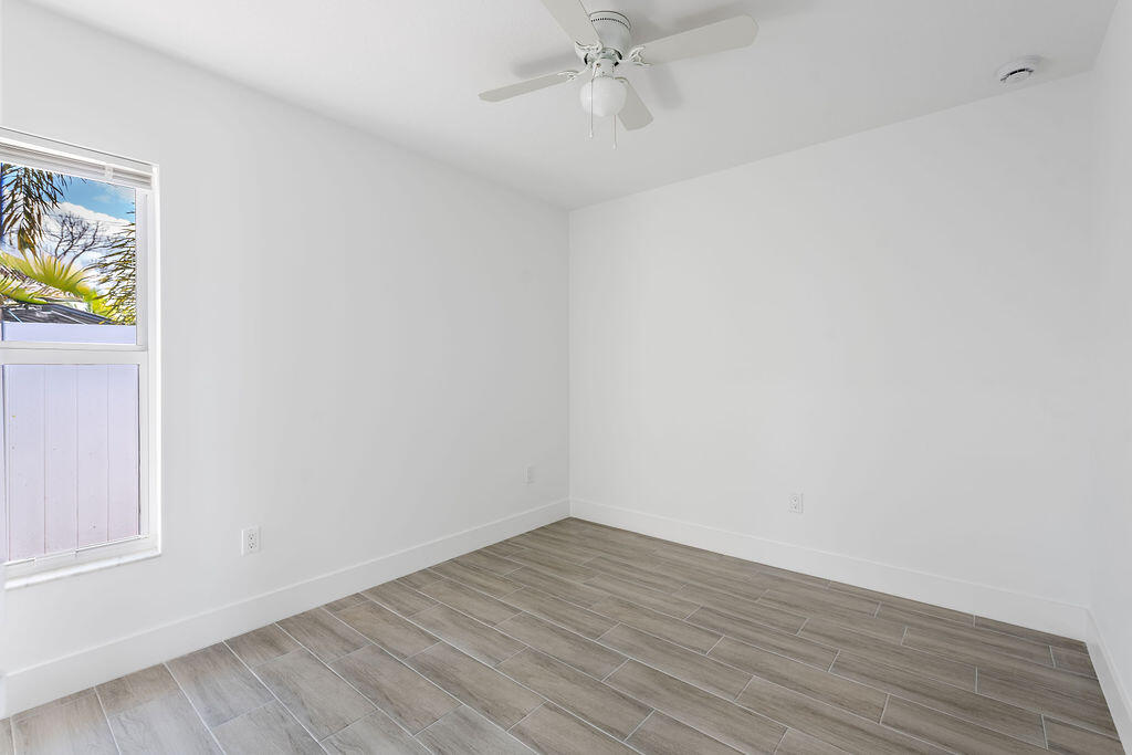 3246 Jefferson Street Stuart, FL 34997 - Photo 14 of 19 a view of an empty room with wooden floor and a window