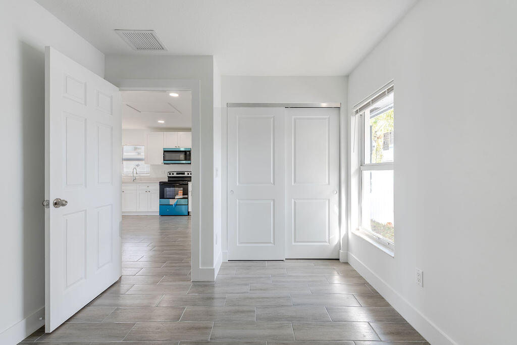 3246 Jefferson Street Stuart, FL 34997 - Photo 15 of 19 a view of empty room with wooden floor and windows