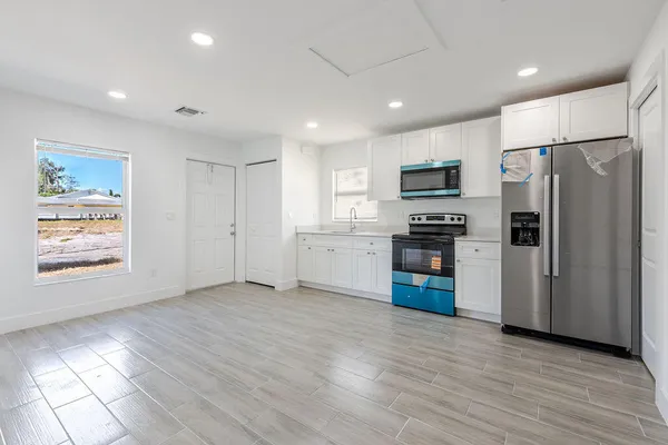 a kitchen with stainless steel appliances a refrigerator and a stove top oven