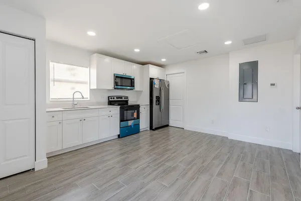 a kitchen with a refrigerator and a sink