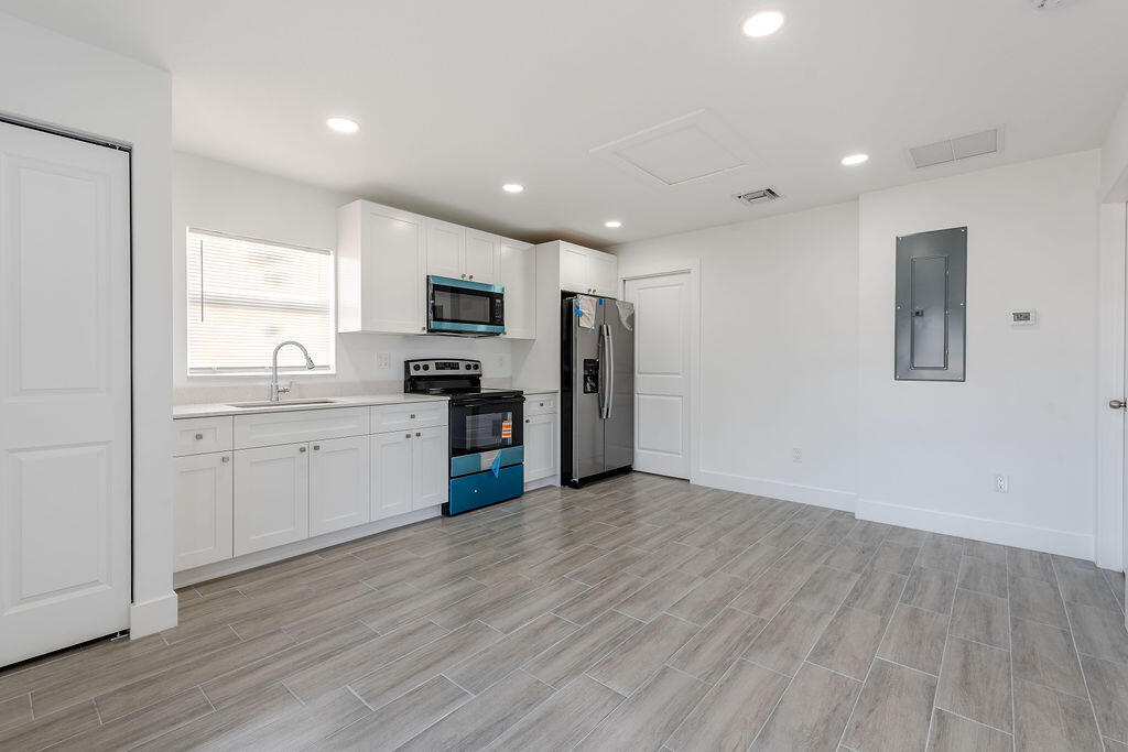 3246 Jefferson Street Stuart, FL 34997 - Photo 5 of 19 a kitchen with a refrigerator and a sink
