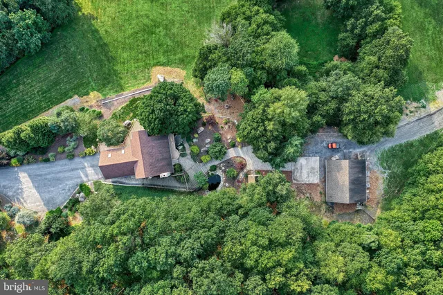 an aerial view of a house with a yard