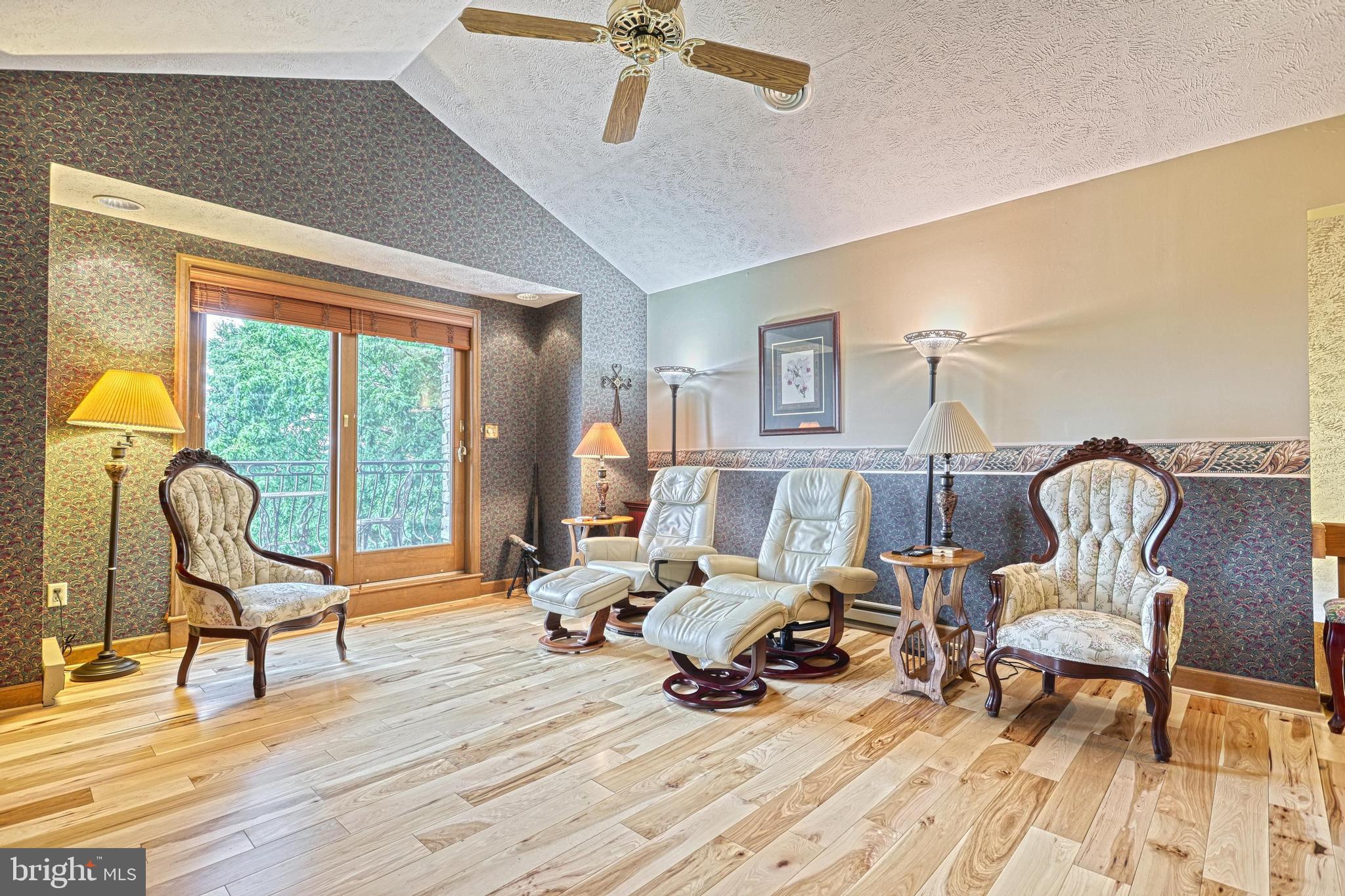 3035 Stillhouse Hollow Road Shippensburg, PA 17257 - Photo 112 of 129 a living room with furniture and a floor to ceiling window