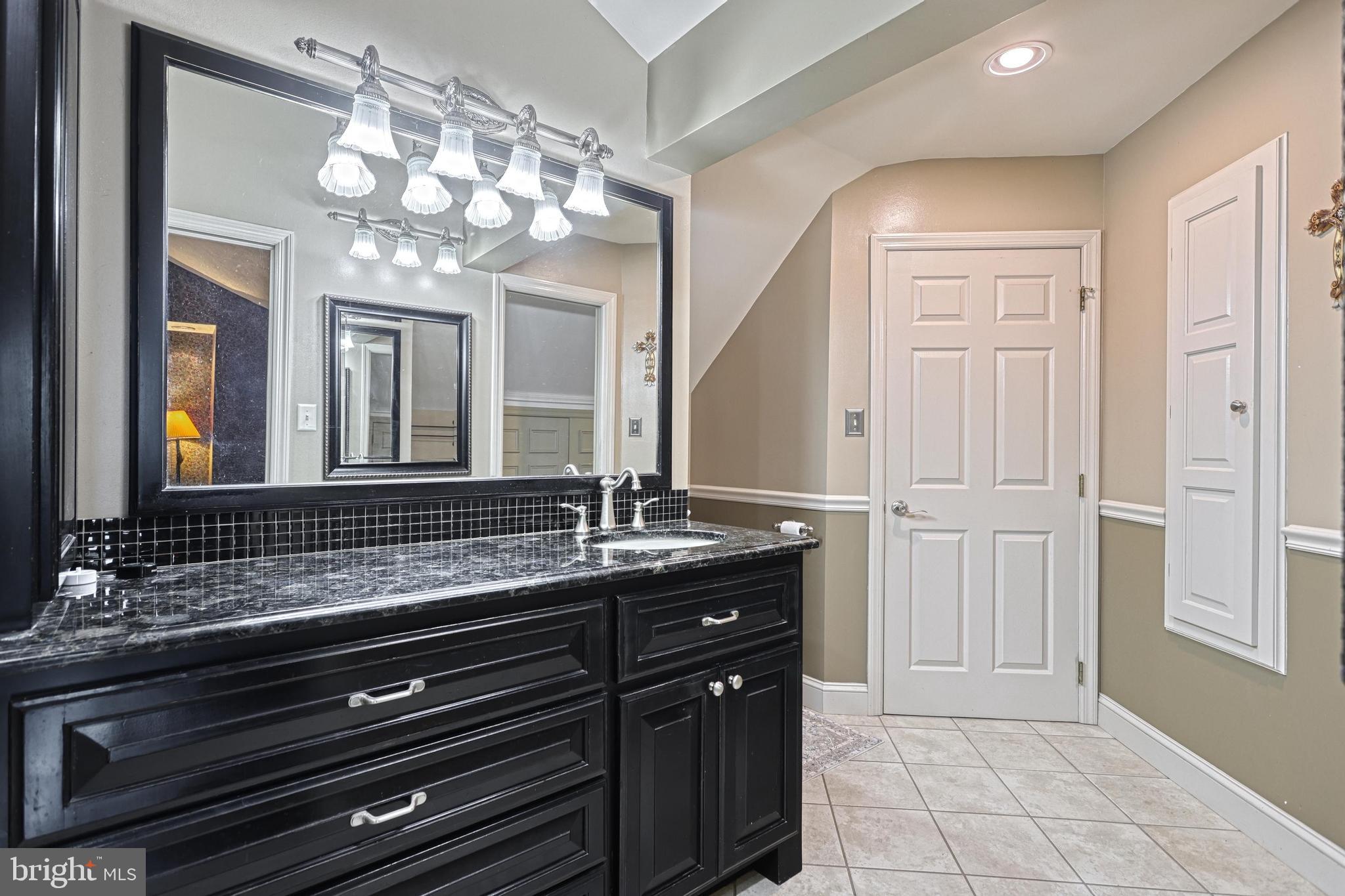 3035 Stillhouse Hollow Road Shippensburg, PA 17257 - Photo 114 of 129 a bathroom with a granite countertop sink a large mirror and a shower