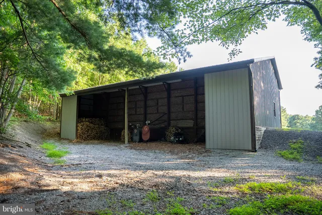 a backyard of a house with a yard and outdoor seating