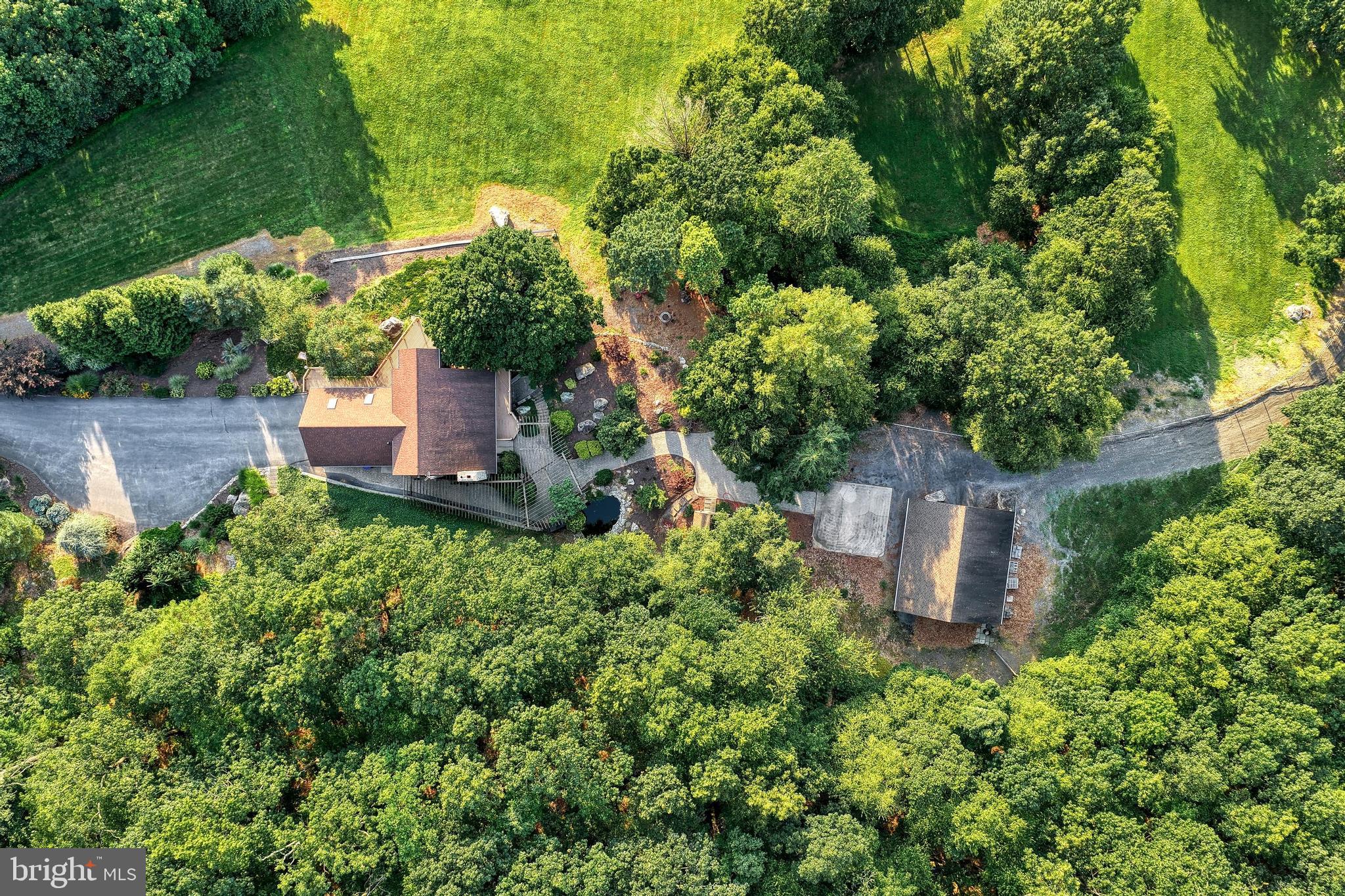 3035 Stillhouse Hollow Road Shippensburg, PA 17257 - Photo 32 of 129 an aerial view of a house with a yard and large trees