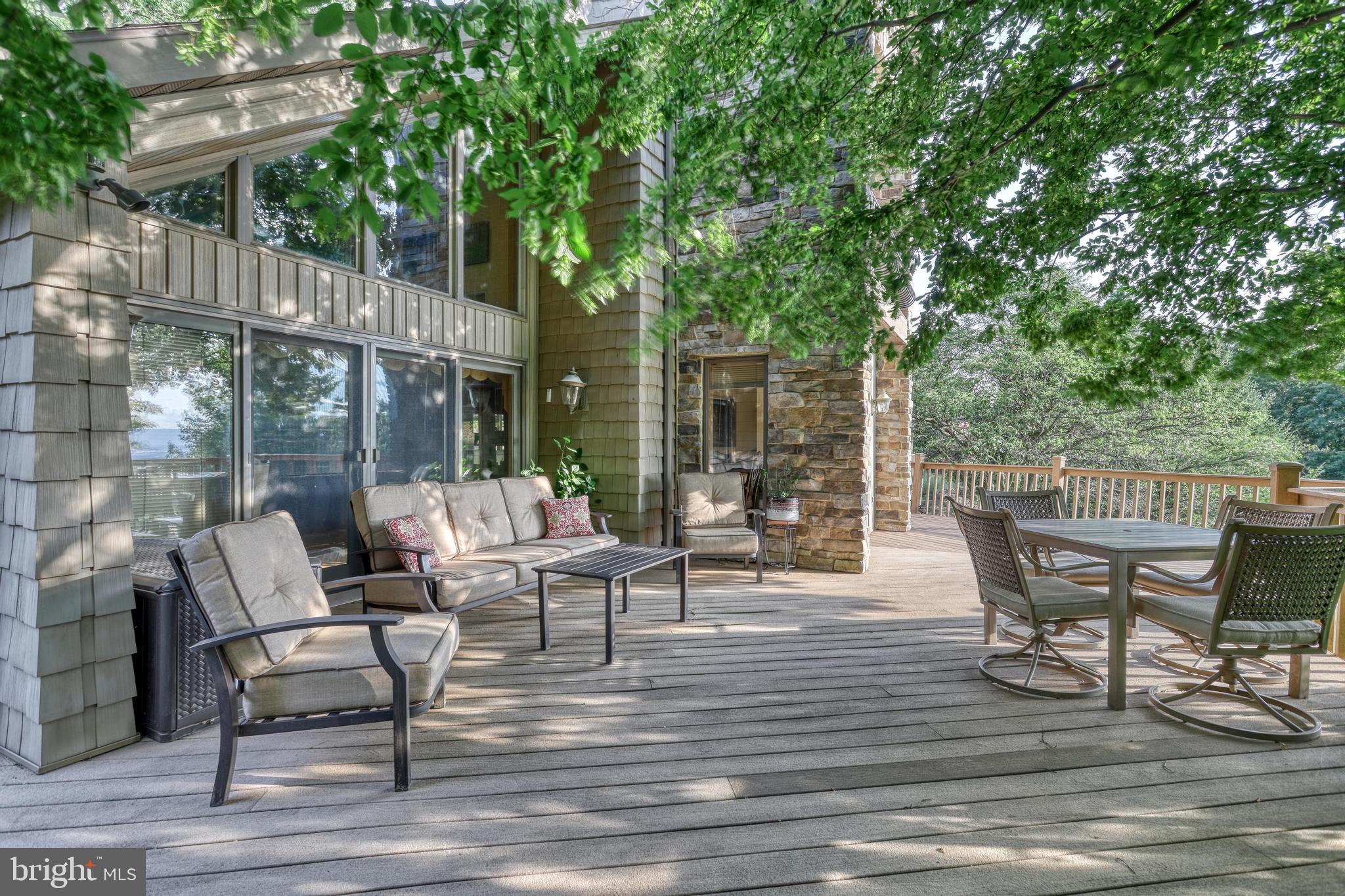3035 Stillhouse Hollow Road Shippensburg, PA 17257 - Photo 65 of 129 a view of a patio with a dining table and chairs with wooden floor