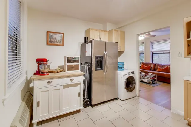 a utility room with cabinets dryer and washer