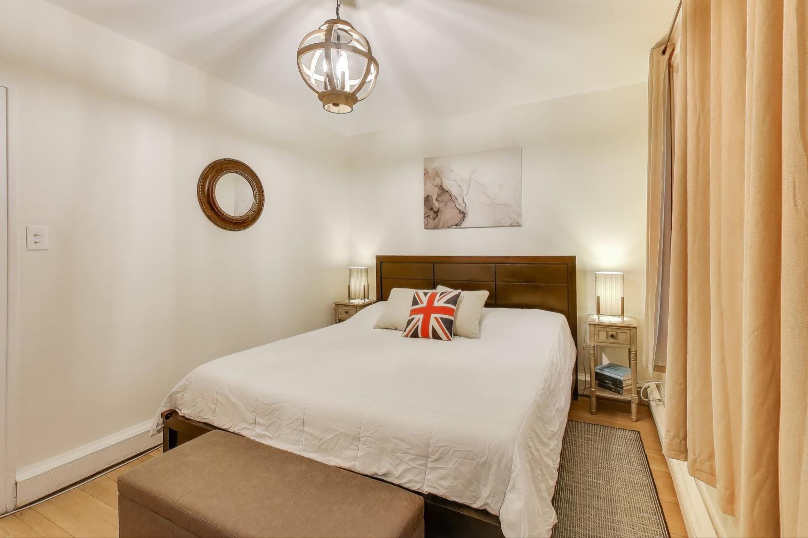 636 West Waveland Avenue, Unit 2E Chicago, IL 60613 - Photo 14 of 23 a bedroom with a bed and a chandelier