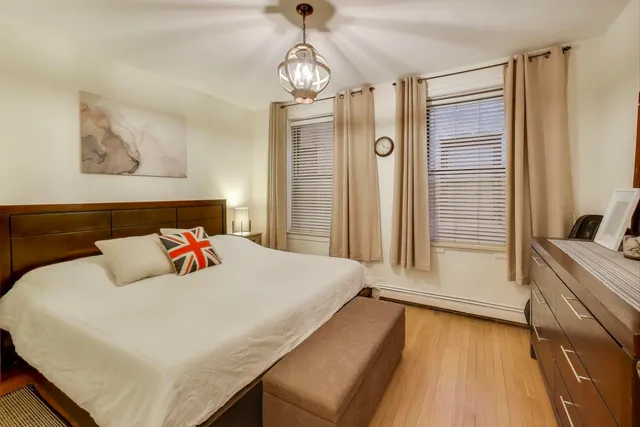 a bedroom with a bed and a chandelier