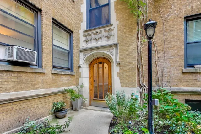 a front view of a house with plants