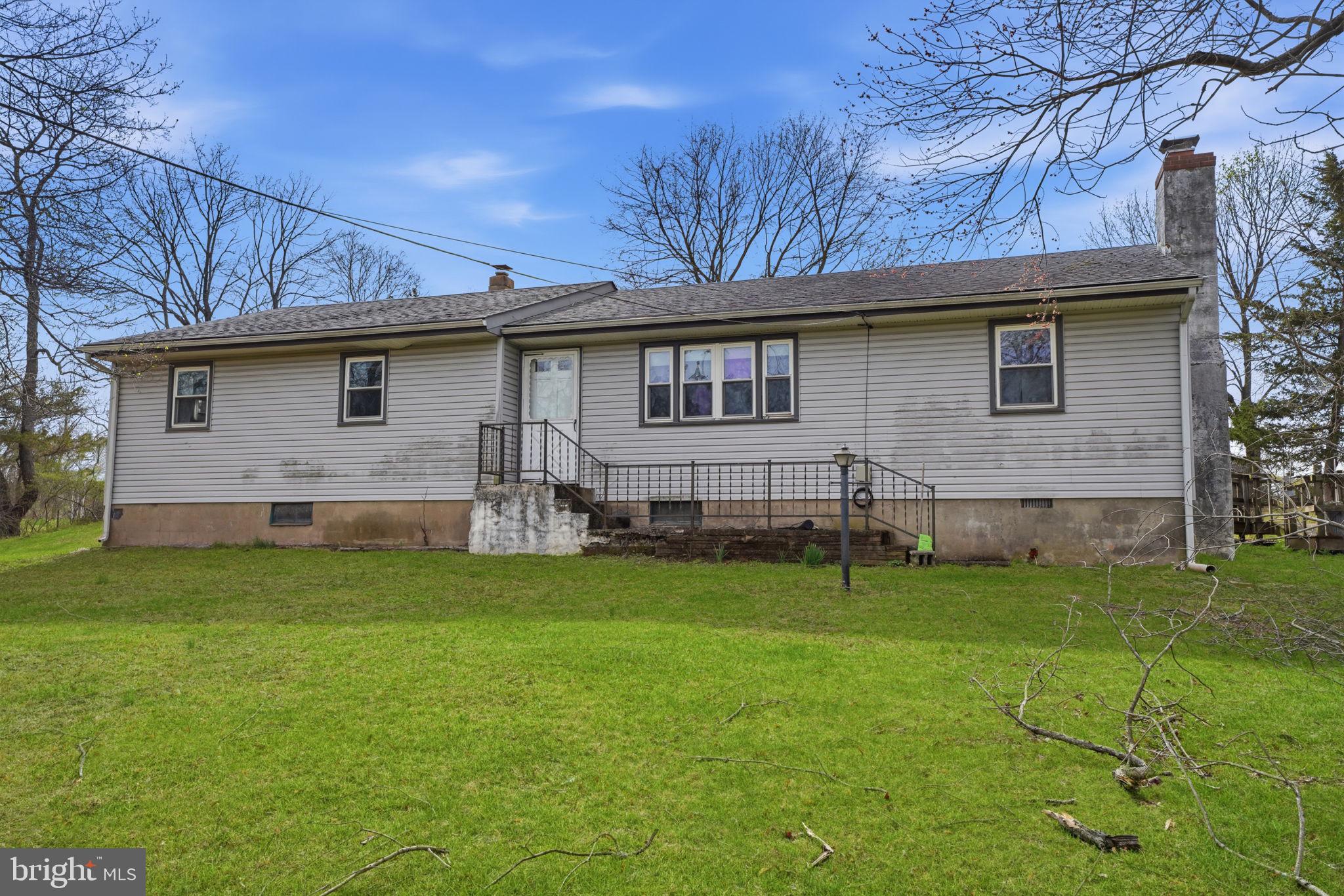 34 Aqueduct Road Washington Crossing, PA 18977 - Photo 2 of 38 a backyard of a house with table and chairs