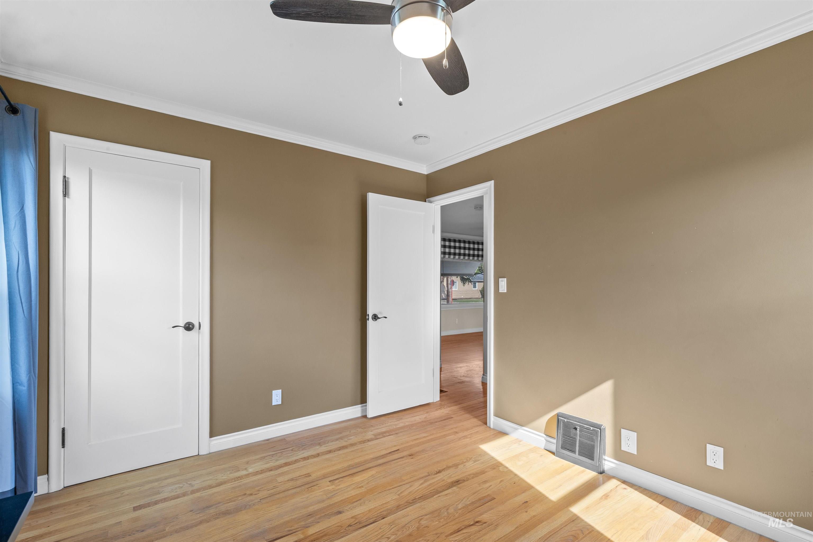 1303 4th Street Clarkston, WA 99403 - Photo 11 of 32 Unfurnished bedroom with ornamental molding, light wood-style flooring, and a ceiling fan