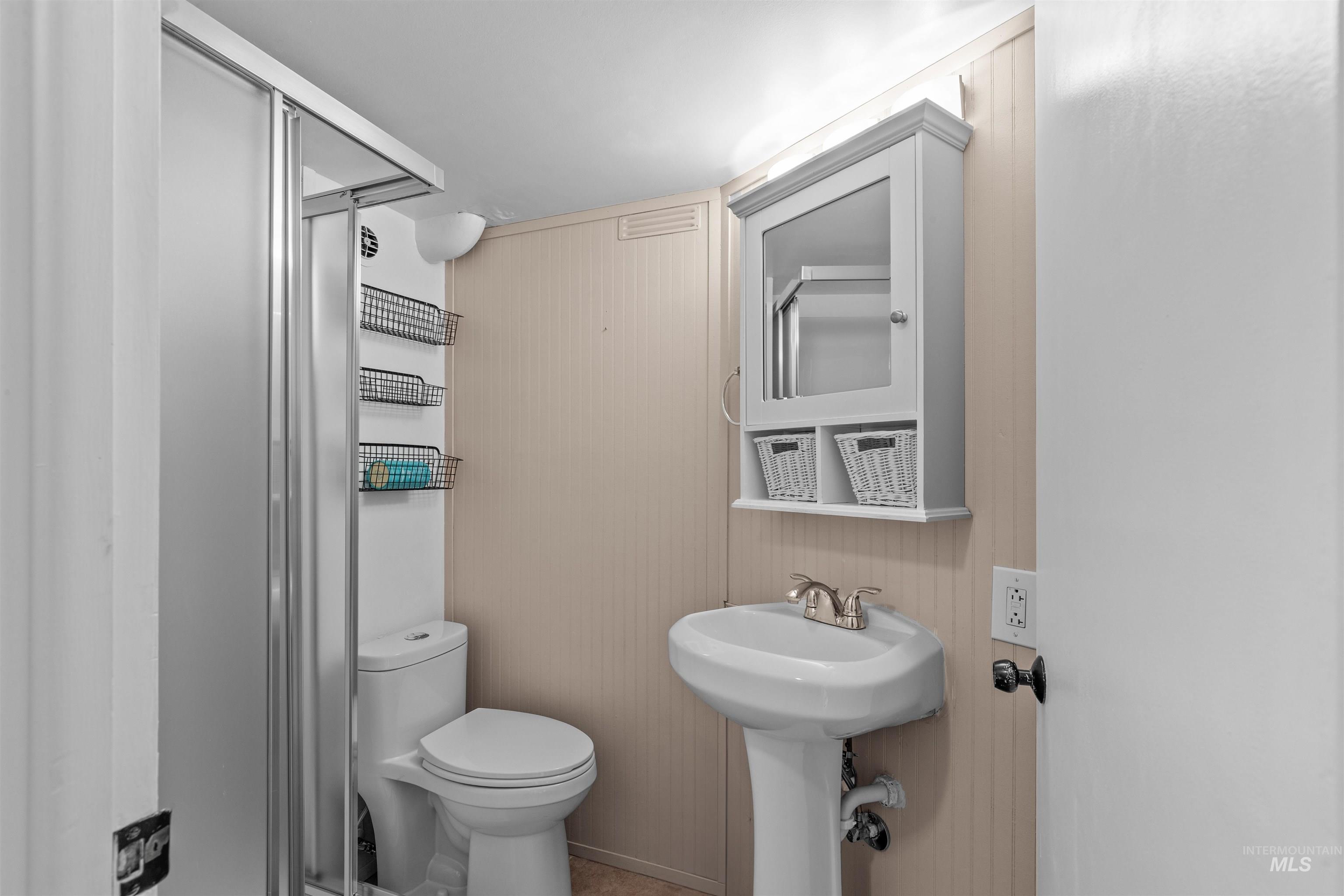 1303 4th Street Clarkston, WA 99403 - Photo 13 of 32 Full bathroom featuring a stall shower and wood walls