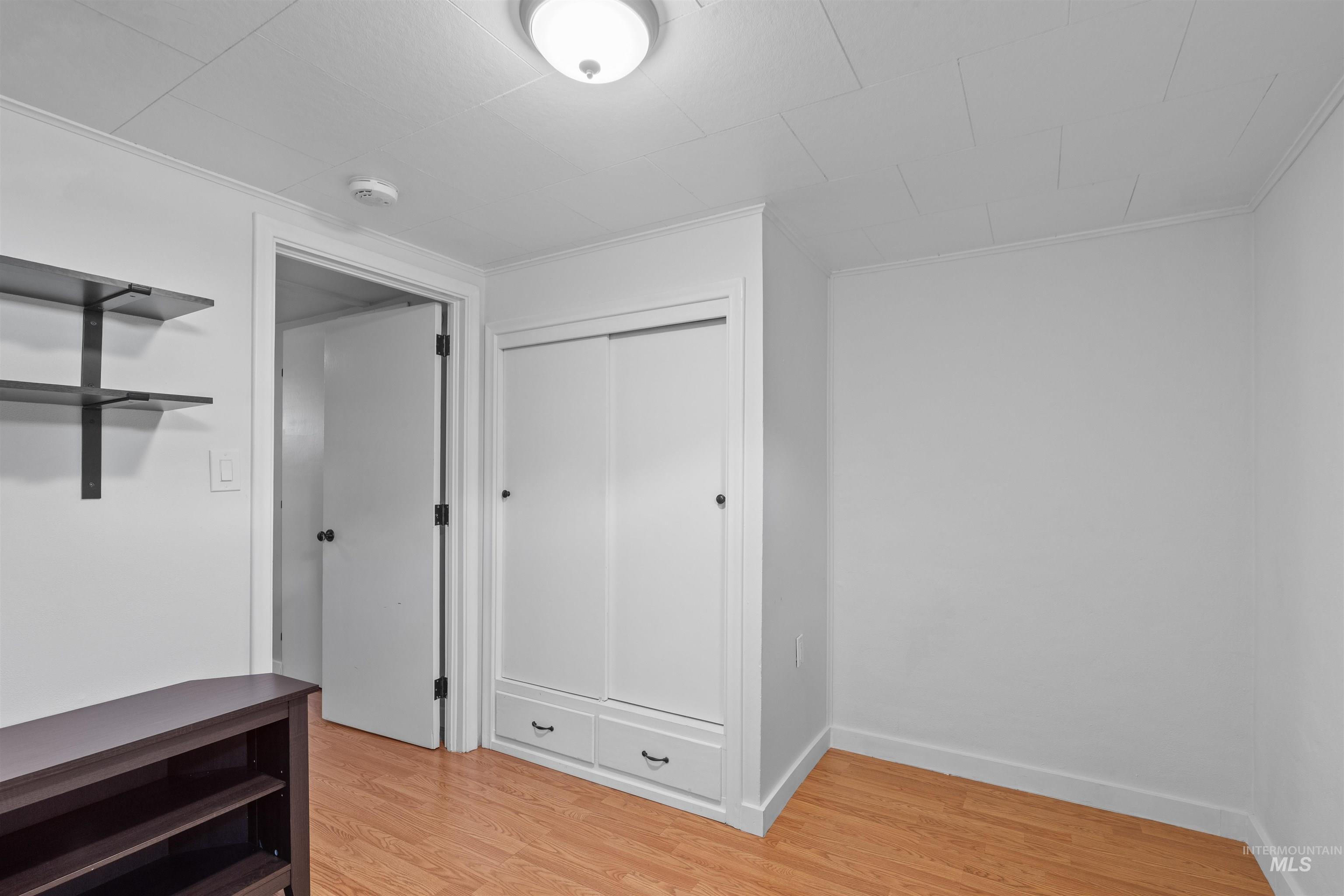 1303 4th Street Clarkston, WA 99403 - Photo 16 of 32 Unfurnished bedroom with light wood-type flooring and a closet