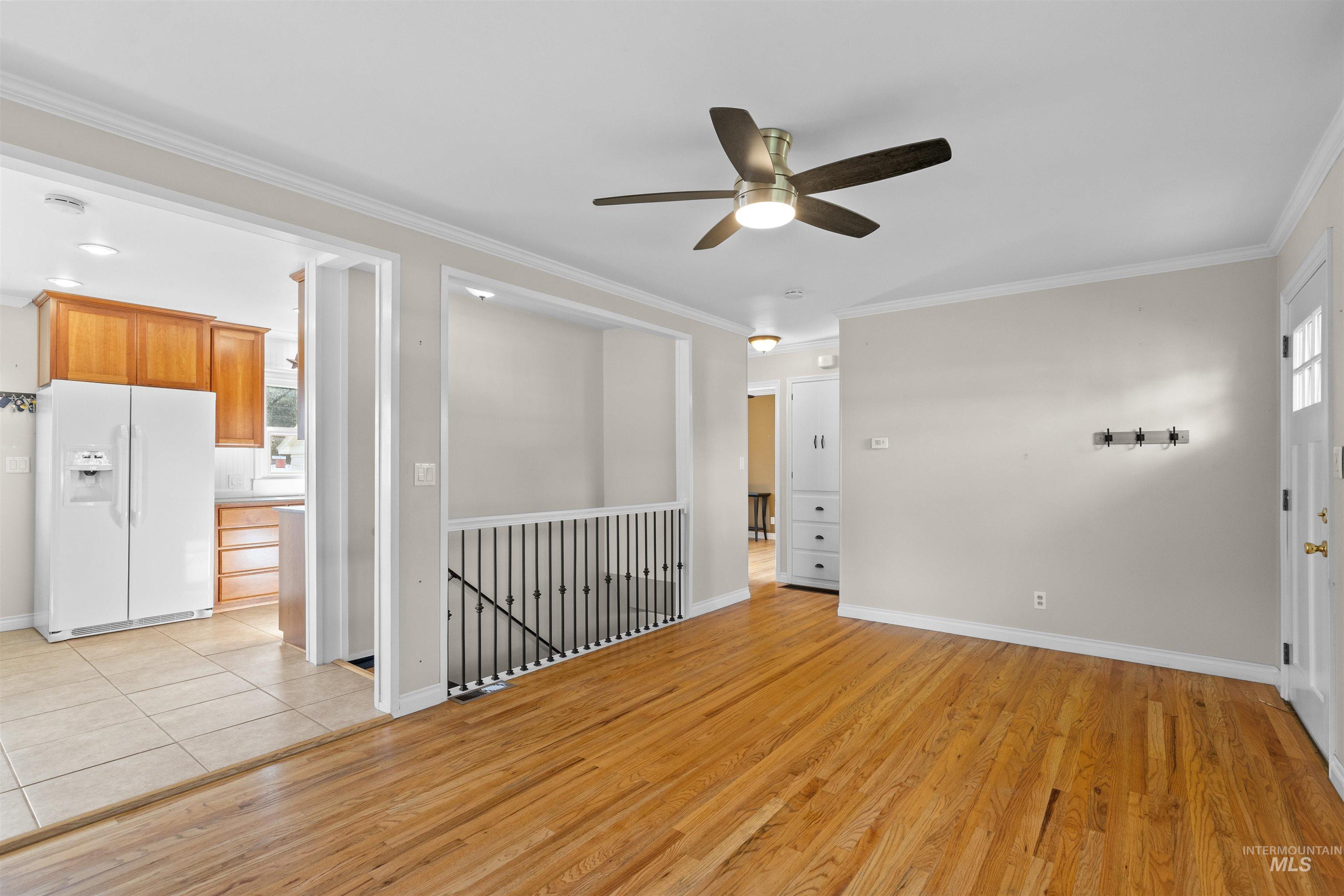 1303 4th Street Clarkston, WA 99403 - Photo 4 of 32 Empty room with crown molding, light wood-type flooring, and ceiling fan