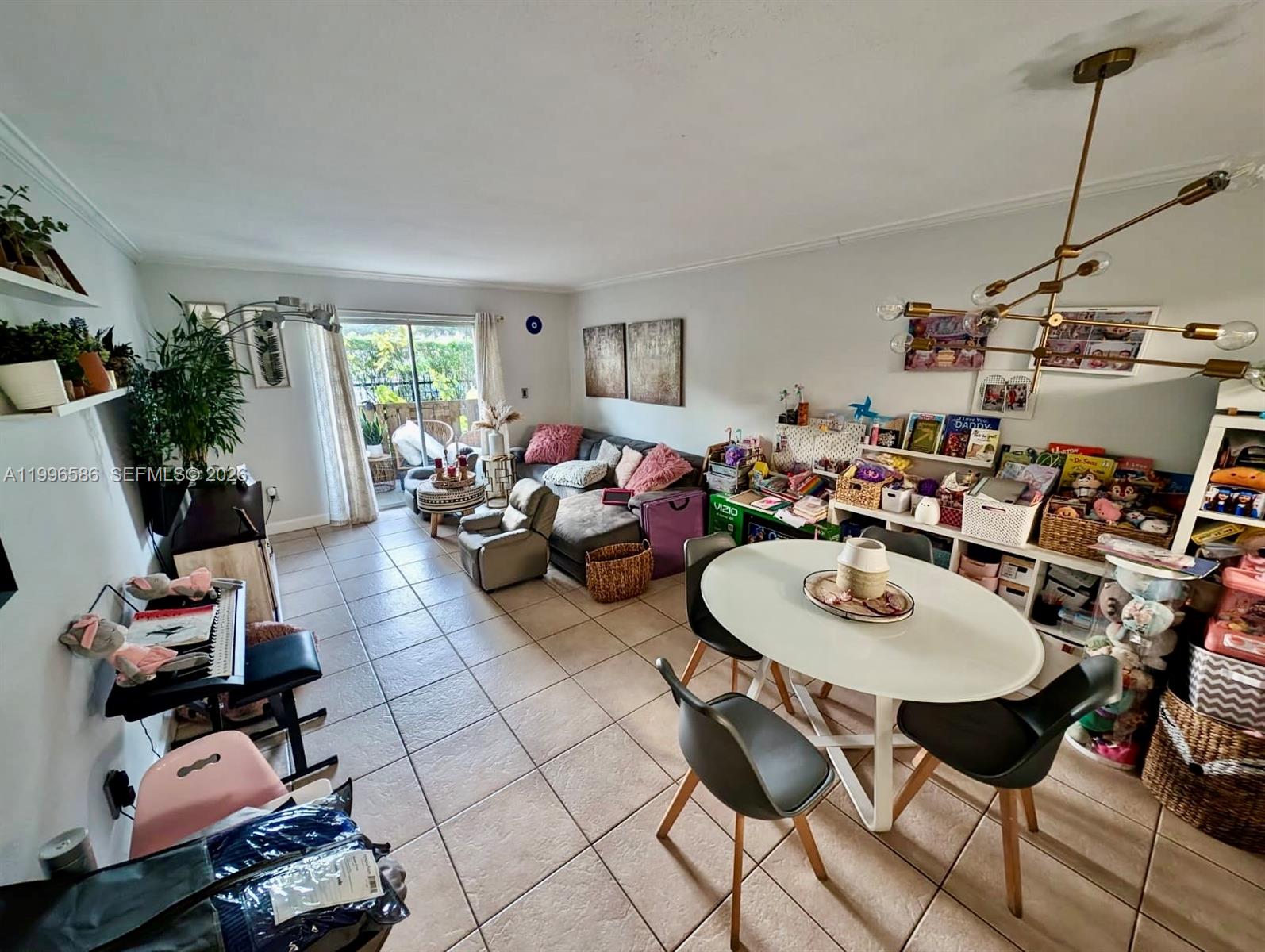 8550 Southwest 109th Avenue, Unit 5101 Miami, FL 33173 - Photo 2 of 8 a living room with furniture and a window