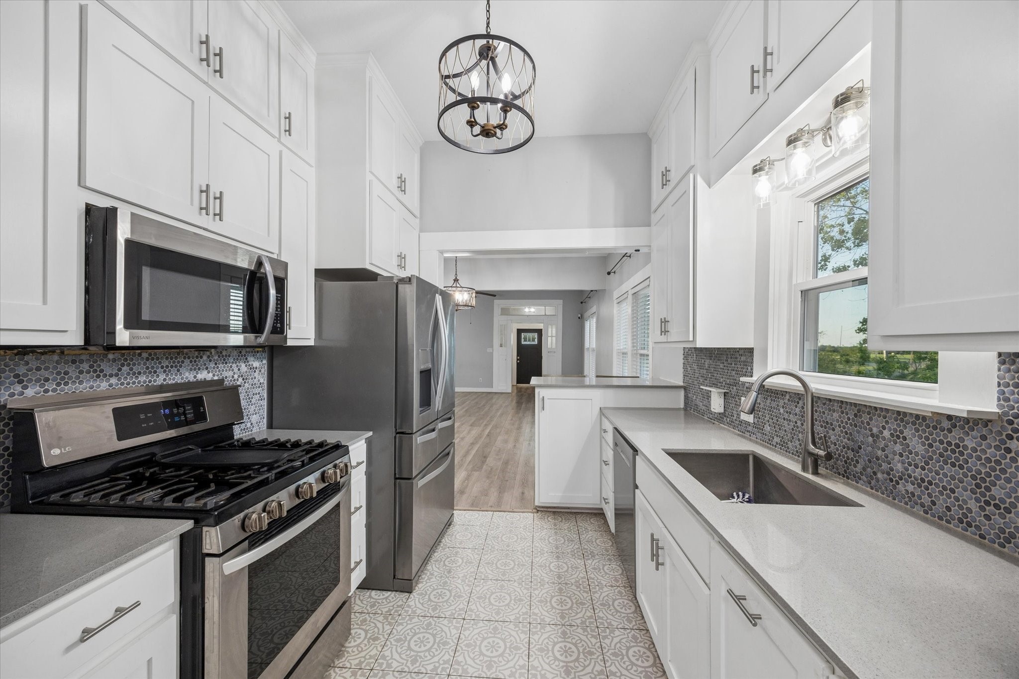 10347 Pless Road Cat Spring, TX 78933 - Photo 12 of 41 a kitchen with stainless steel appliances granite countertop a sink a stove oven and refrigerator