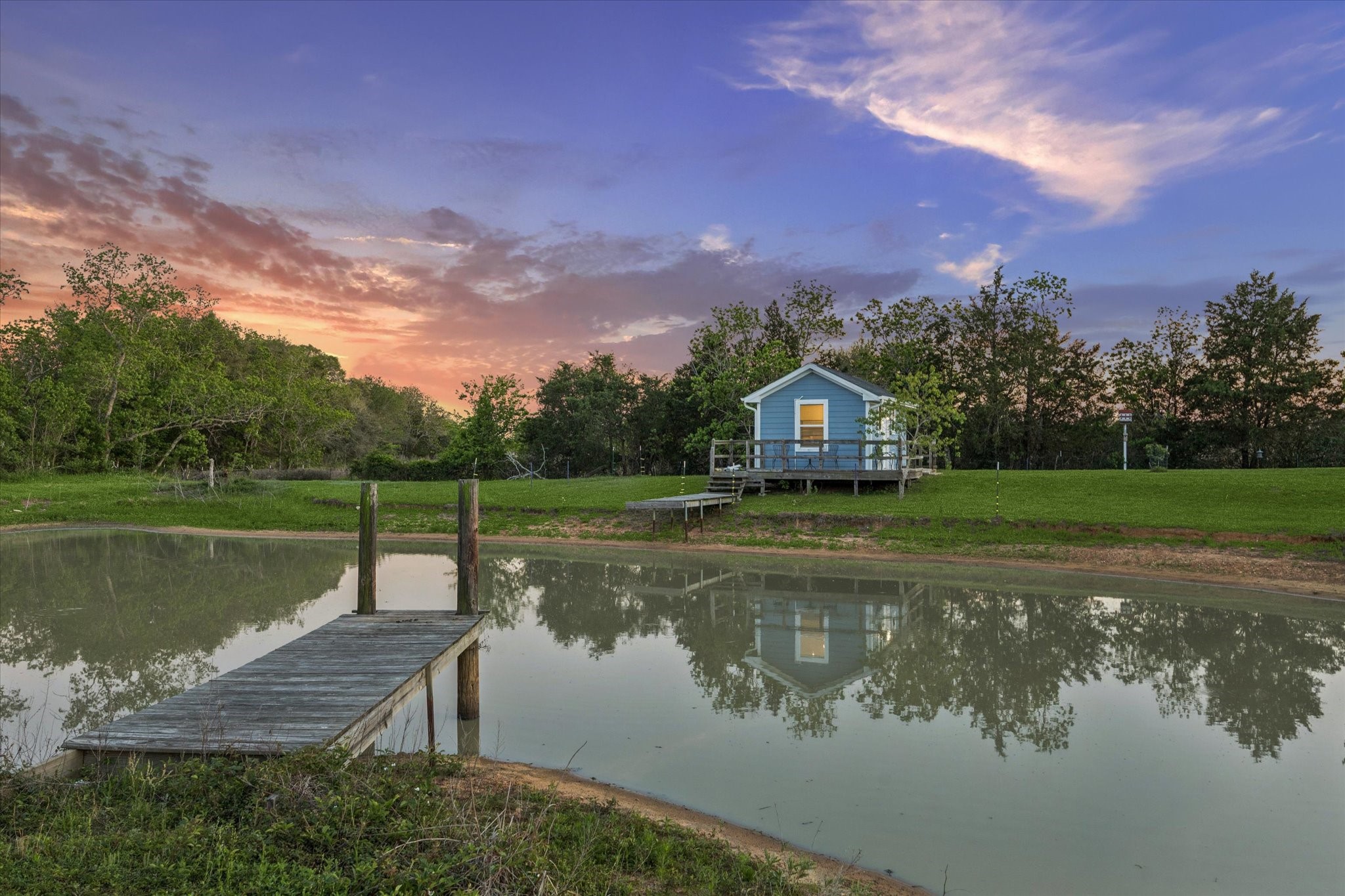10347 Pless Road Cat Spring, TX 78933 - Photo 26 of 41 a view of a lake with a house in the background
