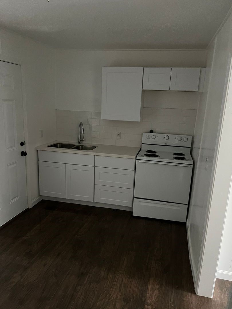 531 East 8th Street Freeport, TX 77541 - Photo 6 of 10 a kitchen with a sink and cabinets