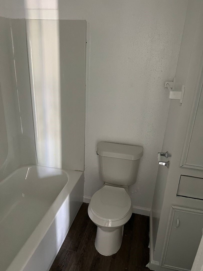 531 East 8th Street Freeport, TX 77541 - Photo 7 of 10 a white toilet sitting next to a bath tub