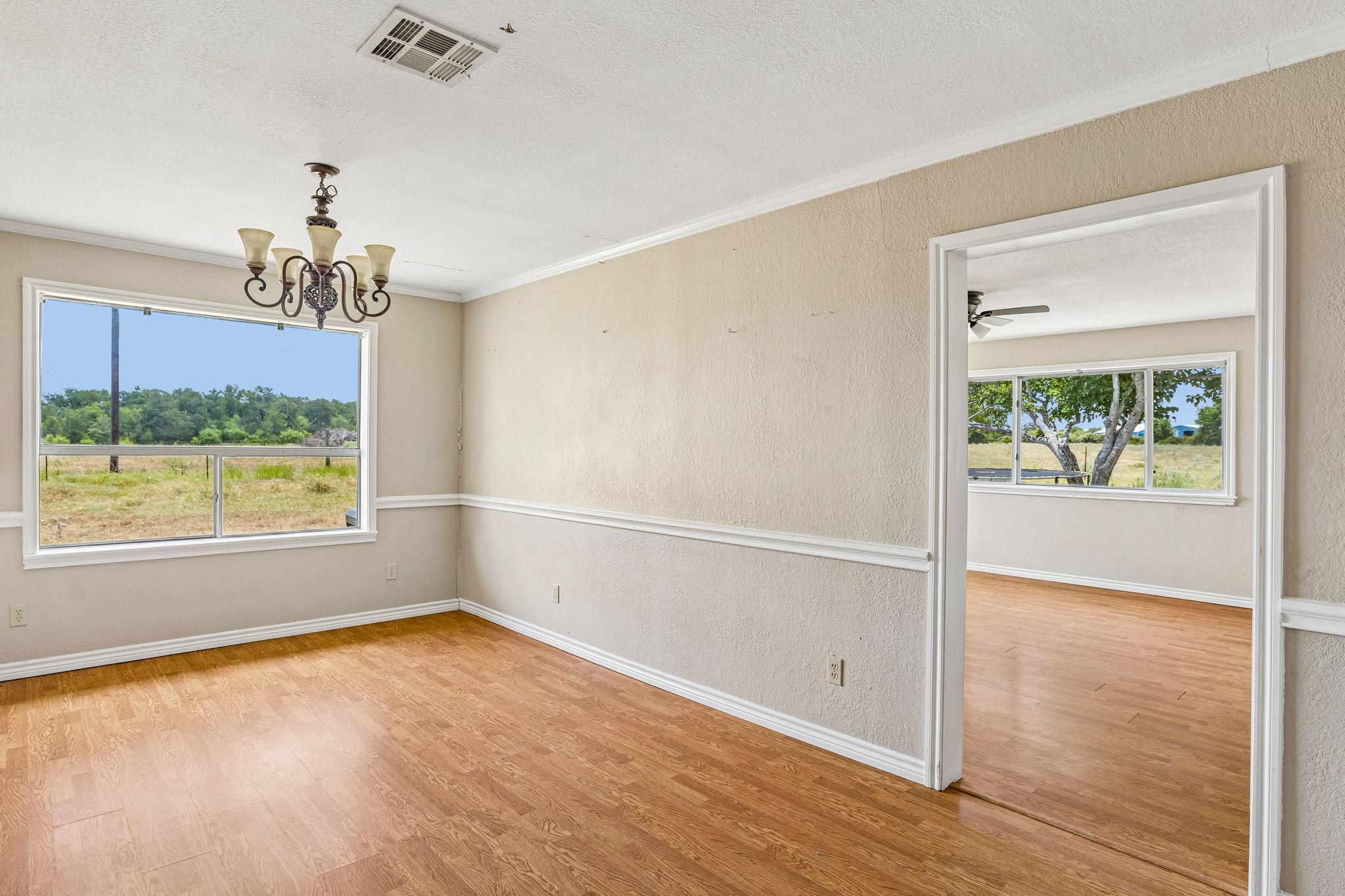 9765 A State Park Road Lockhart, TX 78644 - Photo 9 of 30 A refined dining space with wood flooring and crown molding, ready for memorable meals.