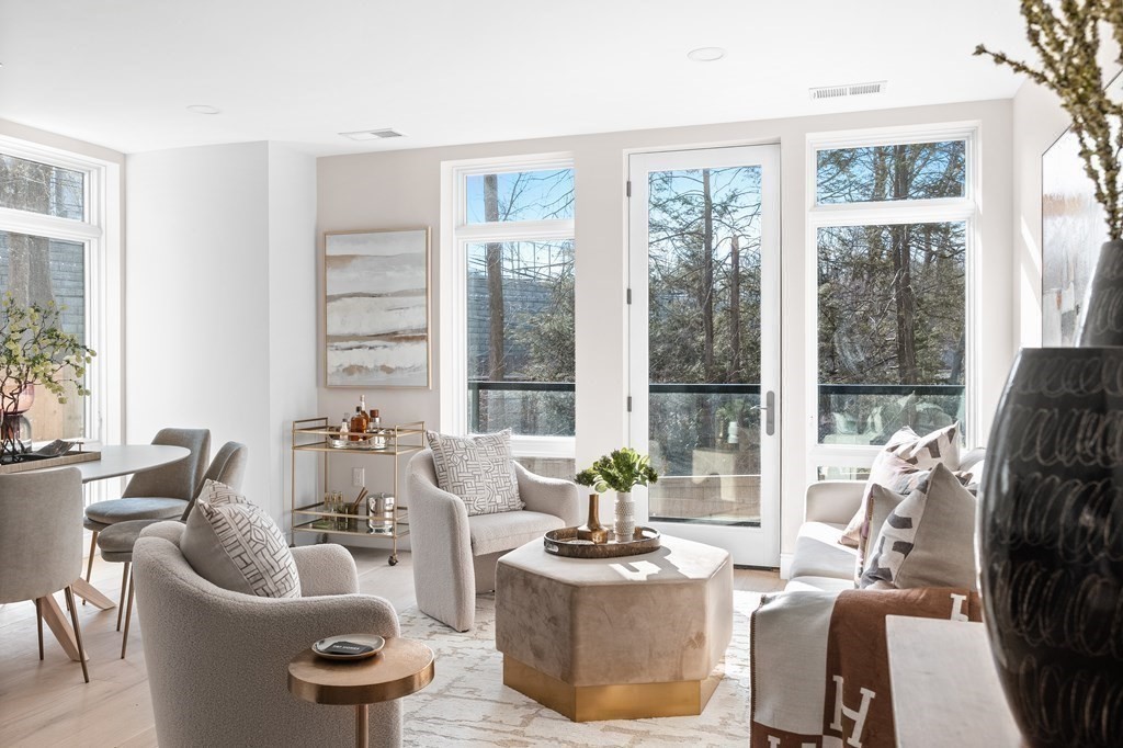 20 Kinmonth Road, Unit 206 Newton, MA 02468 - Photo 4 of 25 a living room with furniture and a large window
