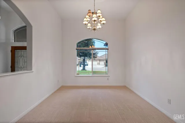 a living room with furniture a ceiling fan and a flat screen tv