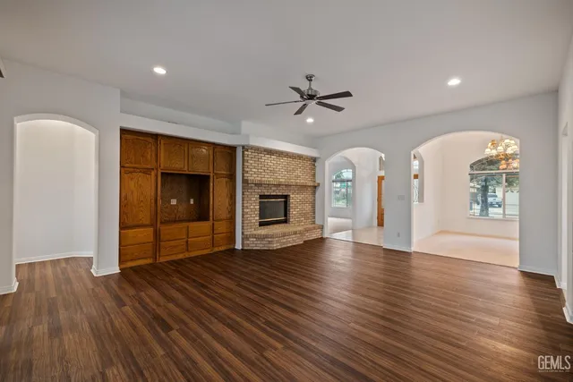 an empty room with closet and a chandelier fan