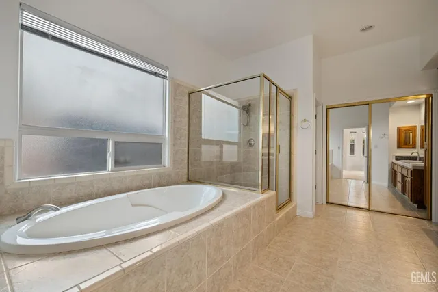 a view of a sink a mirror and window in a room