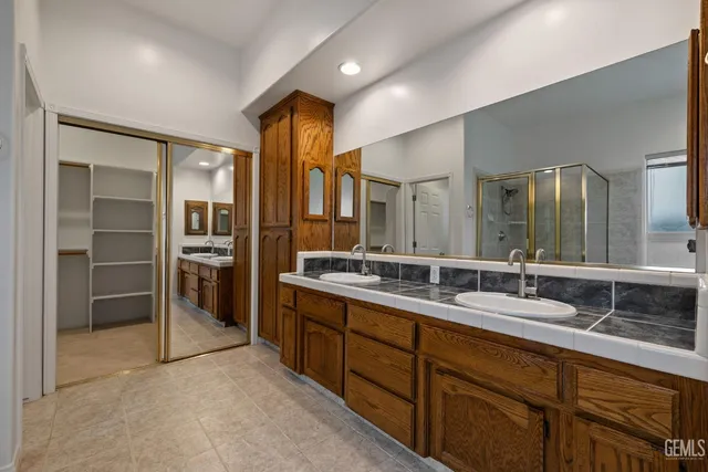 a bathroom with a sink a large mirror and vanity