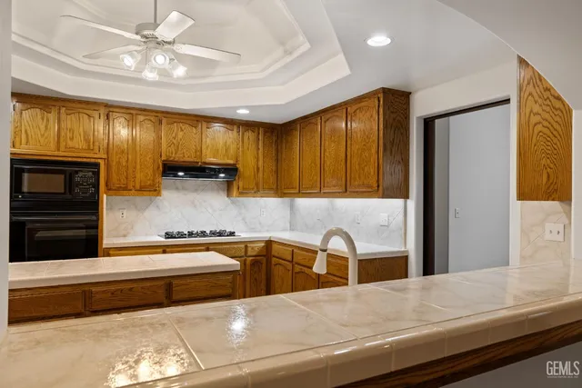a view of kitchen with stainless steel appliances granite countertop a refrigerator and a sink