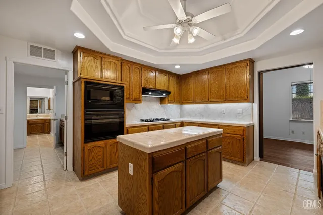 an empty room with a window and ceiling fan