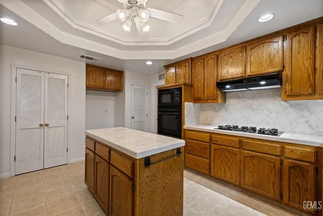 an empty room with a chandelier fan
