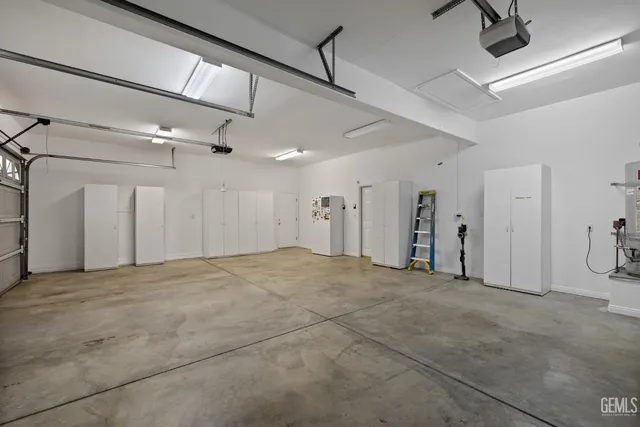 an aerial view of a house with a garden and statue