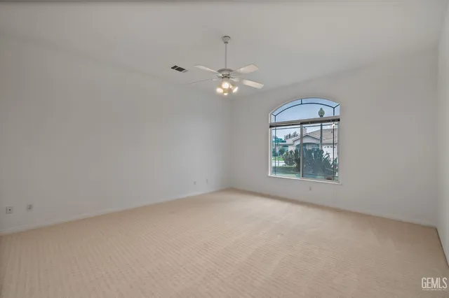 a living room with furniture a chandelier and a window