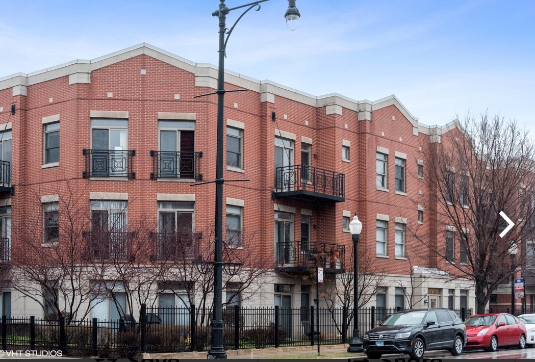 1407 South Halsted Street, Unit 2B Chicago, IL 60607 - Photo 1 of 16 a front view of a building with lot of cars and trees