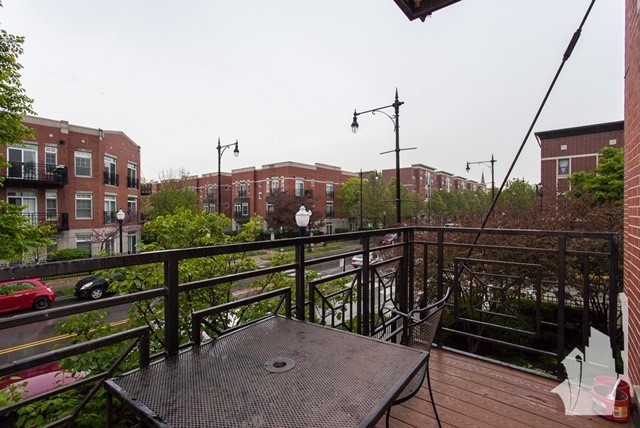 1407 South Halsted Street, Unit 2B Chicago, IL 60607 - Photo 14 of 16 a view of a balcony with wooden floor