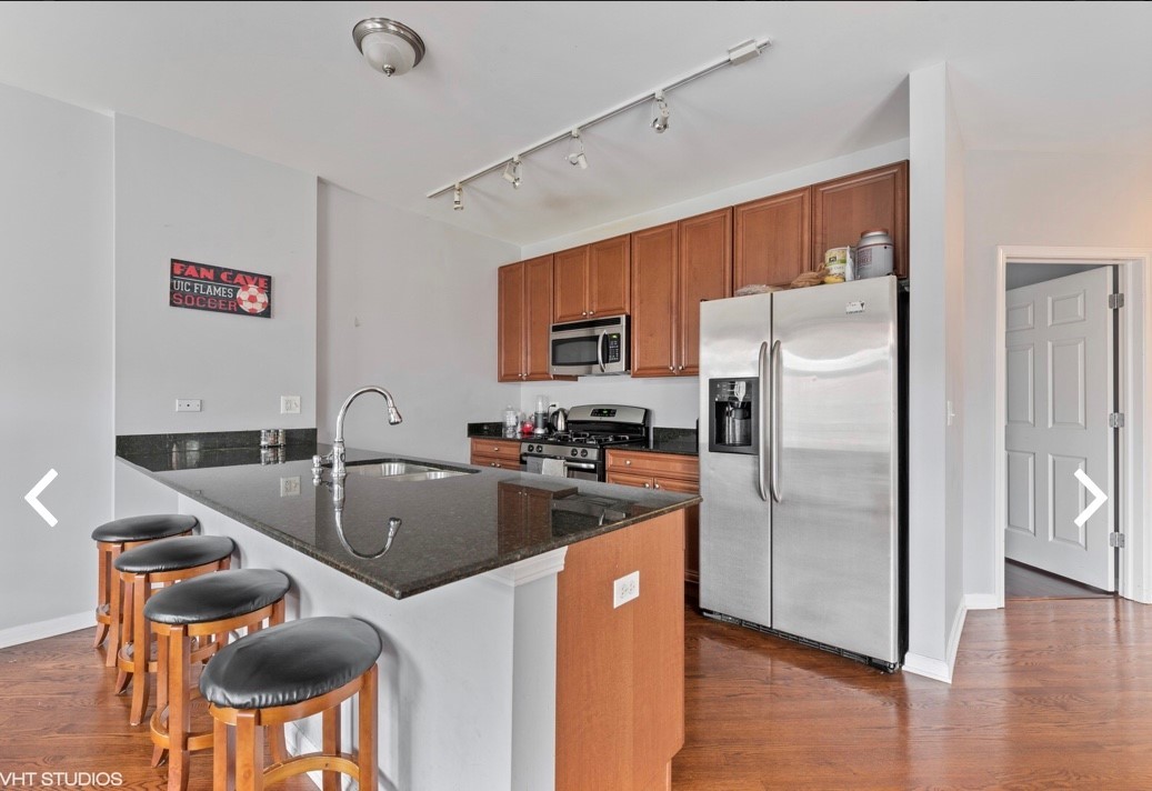 1407 South Halsted Street, Unit 2B Chicago, IL 60607 - Photo 5 of 16 a kitchen with stainless steel appliances granite countertop a refrigerator a sink a stove and a cabinets